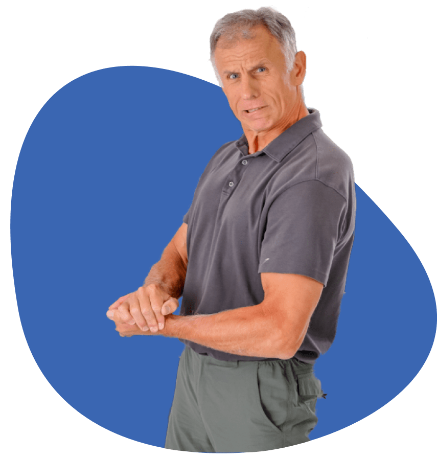 Brad standing and flexing his bicep with a slight grimace.
