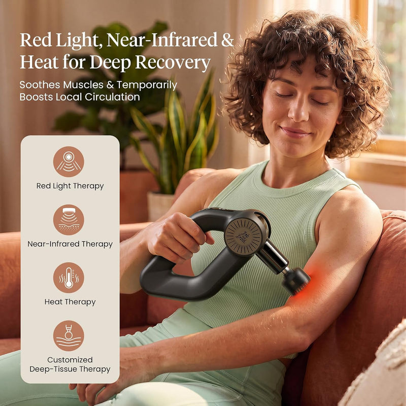 Women sitting on a brown couch using the Bob and Brad D6 massage gun on her bicep using the red light head. text includes: Red light, near-infrared & heat for deep recovery. Soothes muscles & temporarily boosts local circulation. Red light therapy, near-infrared therapy, heat therapy, customized deep-tissue therapy.  