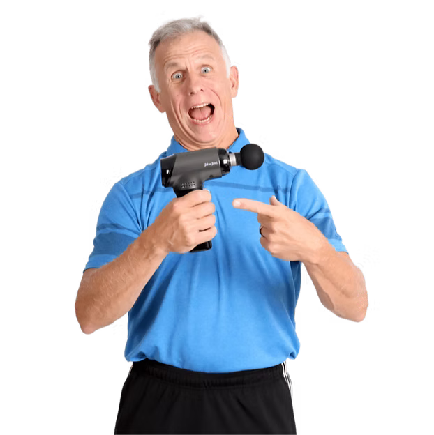 Brad is holding a T2 massage gun with a ball head in one hand and smiling and pointing at it with his other hand. 