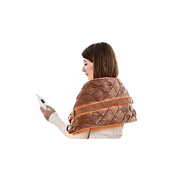 A woman shown from the side and back wearing a brown quilted electric heating wrap around her shoulders and upper back, while holding a white digital thermometer against a plain white background.