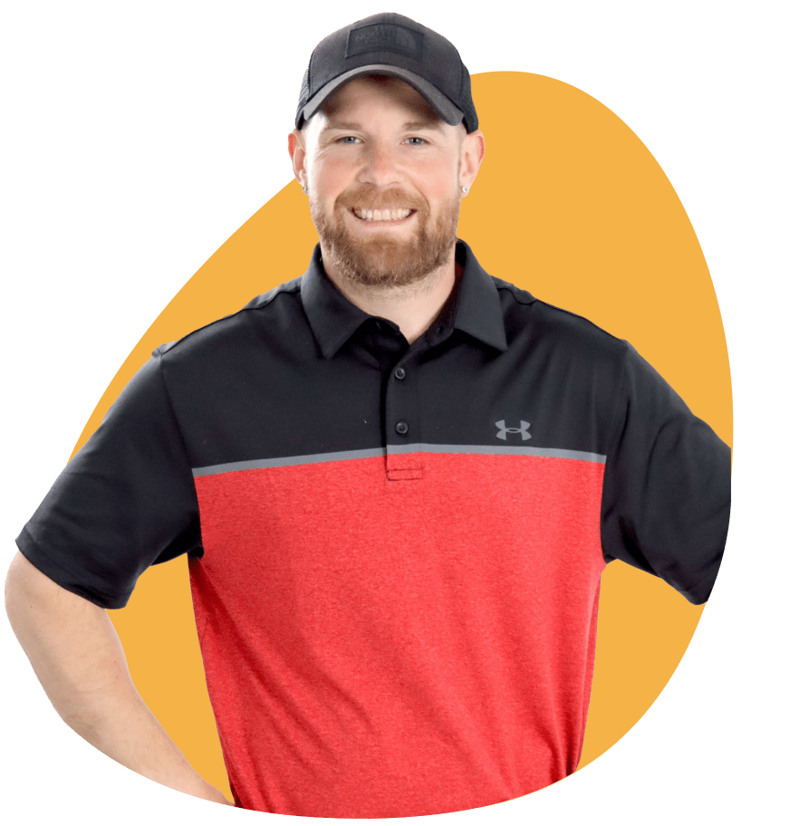 Mike wearing a black and red Under Armour polo shirt with a black baseball cap, set against a green background with a yellow graphic shape.