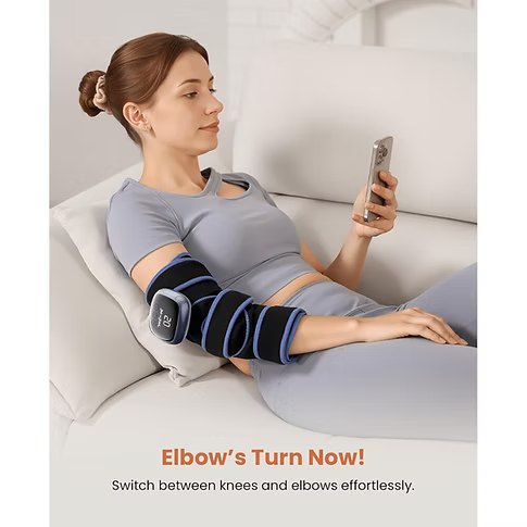 A woman is reclining on a white sofa and looking at her phone, wearing a black and blue TheraHeat wrap on her elbow. Text at the bottom reads 'Elbow's Turn Now! Switch between knees and elbows effortlessly.