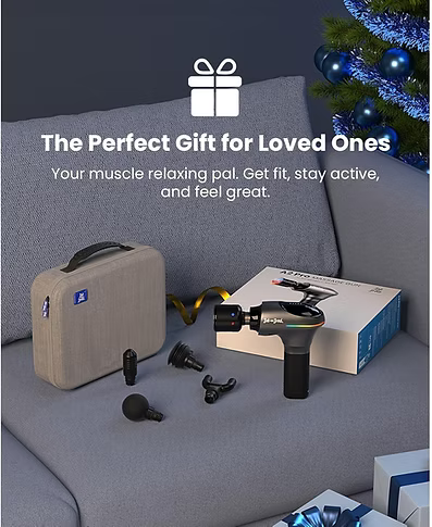 A muscle massager set displayed on a gray sofa with promotional text, including the handheld massager, carrying case, accessories, and product box, with a Christmas tree in the background. Text includes: The perfect gift for loved ones. Your muscle-relaxing pal. Get fit, stay active, and feel great. 