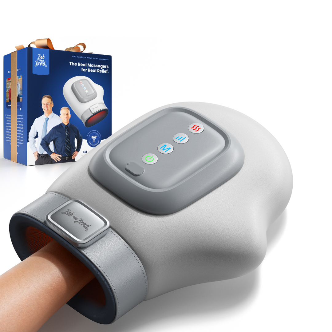 Grey handheld massage device with digital display and control buttons, next to its packaging on a white background.